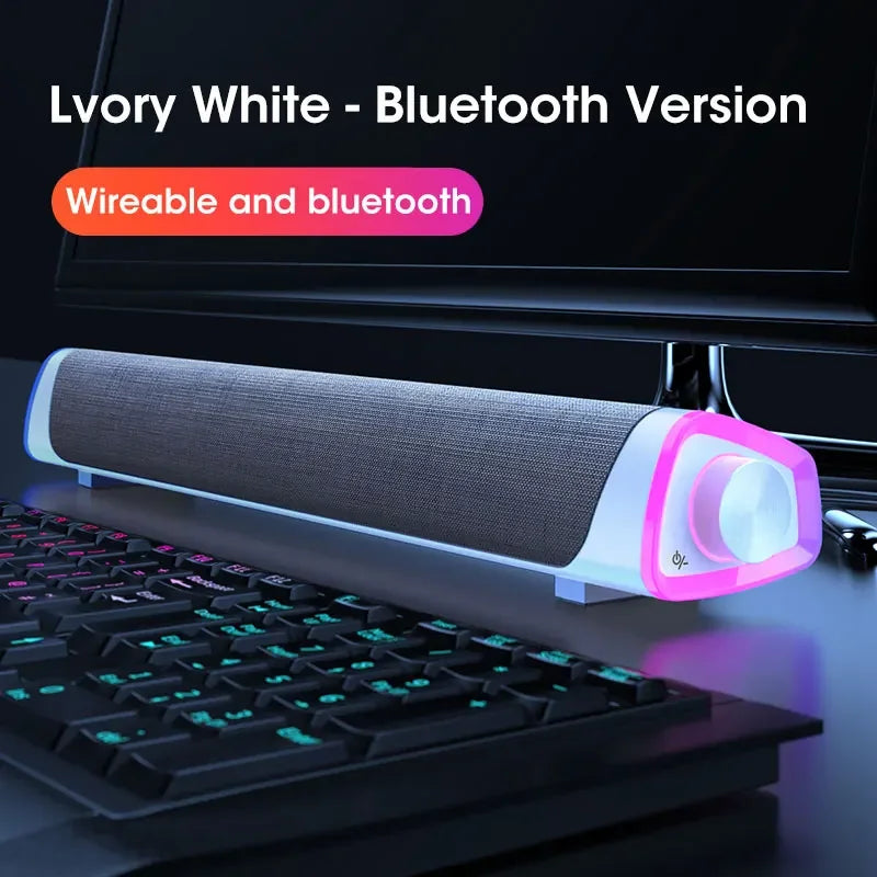 Soundbar with Bluetooth and wired options on a desk with keyboard and monitor
