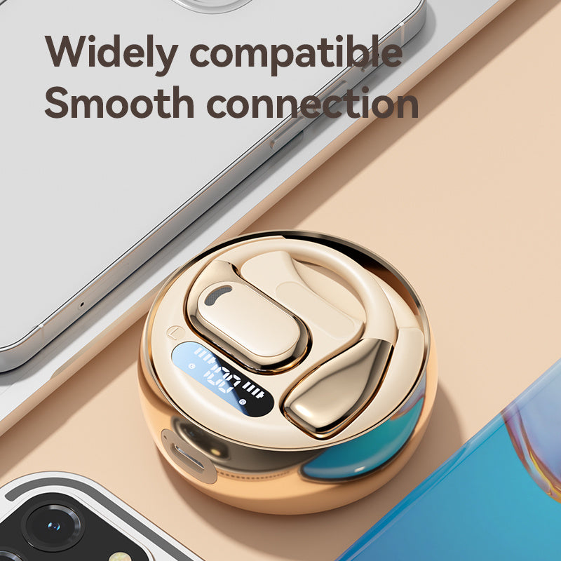 Gold and blue electronic device on a beige surface with smartphone in the background