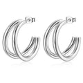 A pair of polished silver hoop earrings with a triple-ring design, displayed on a clean white background.