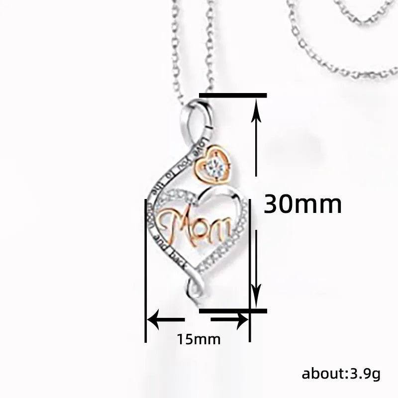 Heart-shaped pendant with 'Mom' engraving and measurements on a white background