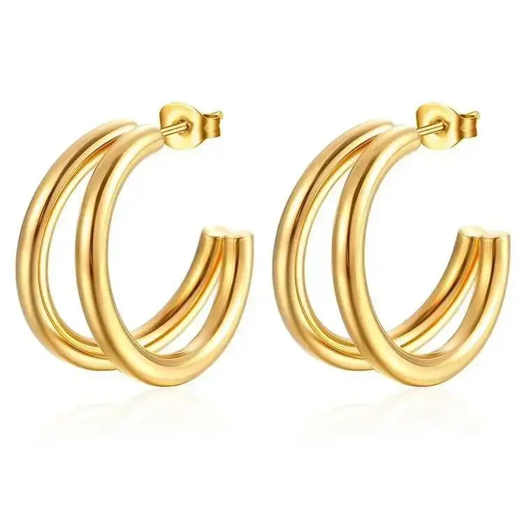 A pair of gold hoop earrings with a triple-ring design, shown on a clean white background.