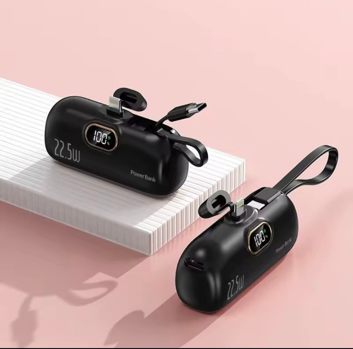 Black power banks with digital displays on a pink background- Lynda Kay's Shop