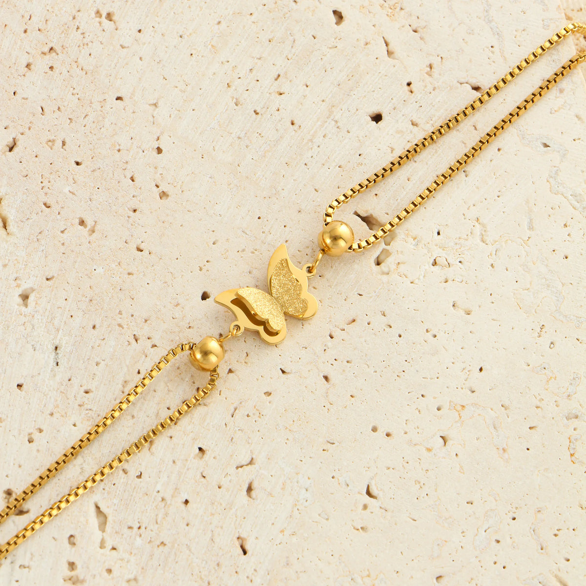 Frosted butterfly anklet in gold and silver tones