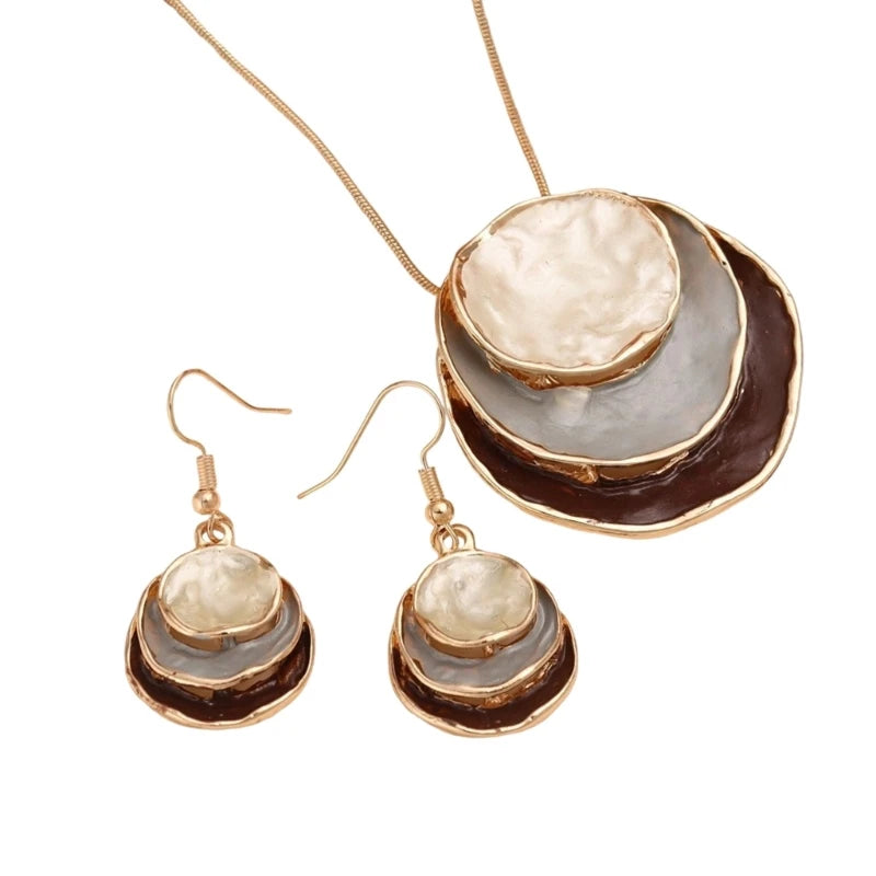 Jewelry set with necklace and earrings featuring layered circular designs on a white background