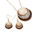 Jewelry set with necklace and earrings featuring layered circular designs on a white background