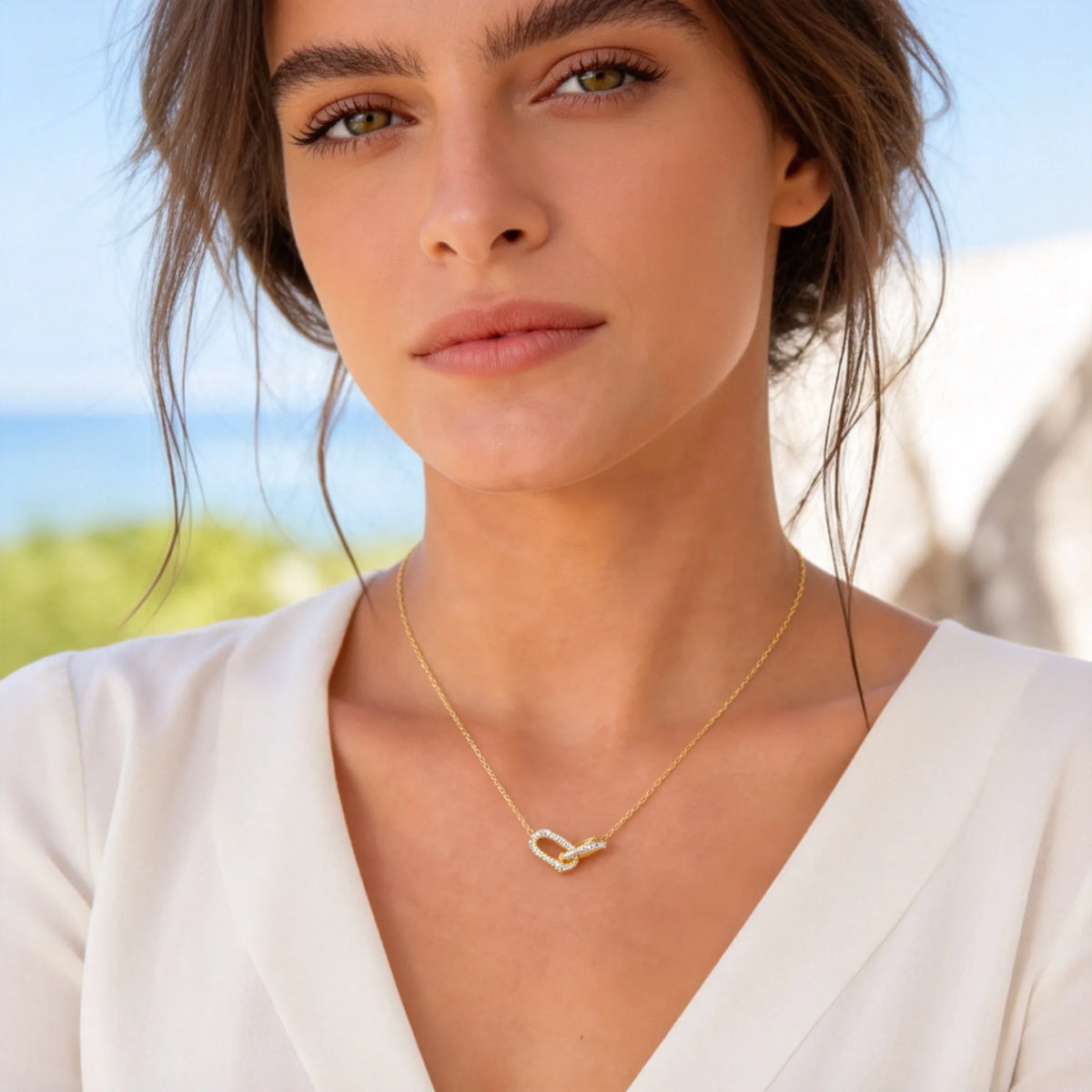 Gold interlocking heart paperclip necklace with clear zircon accents