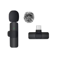 Black microphone with windscreen and USB-C connector on a white background