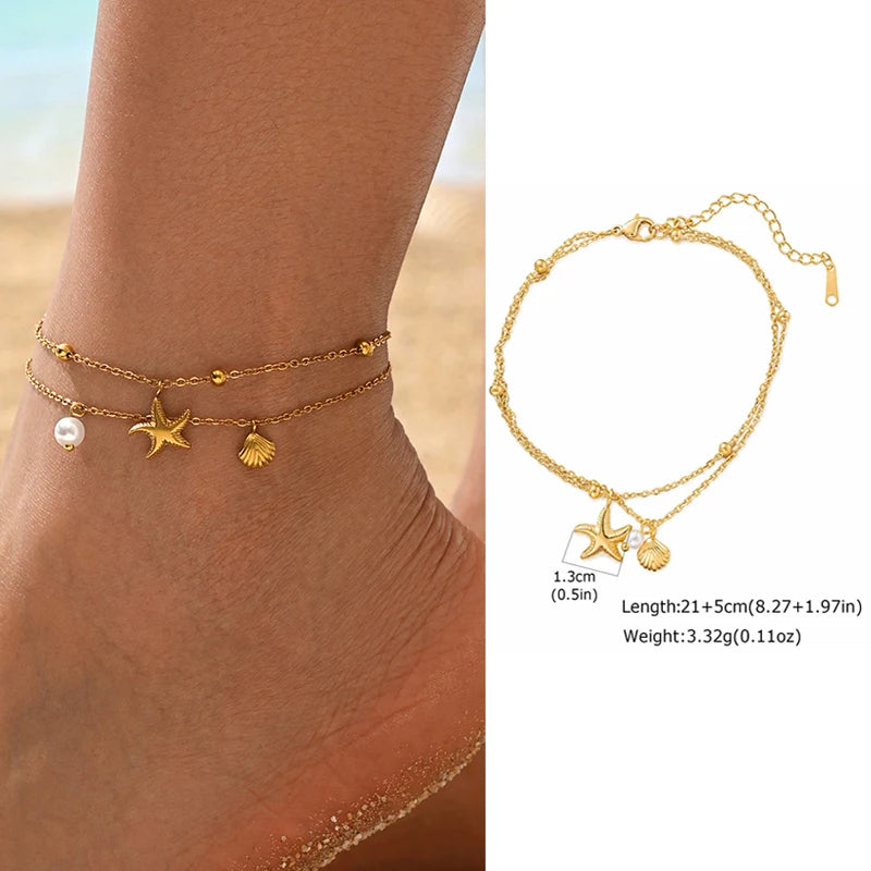 Gold anklets with star and shell charms on a beach setting