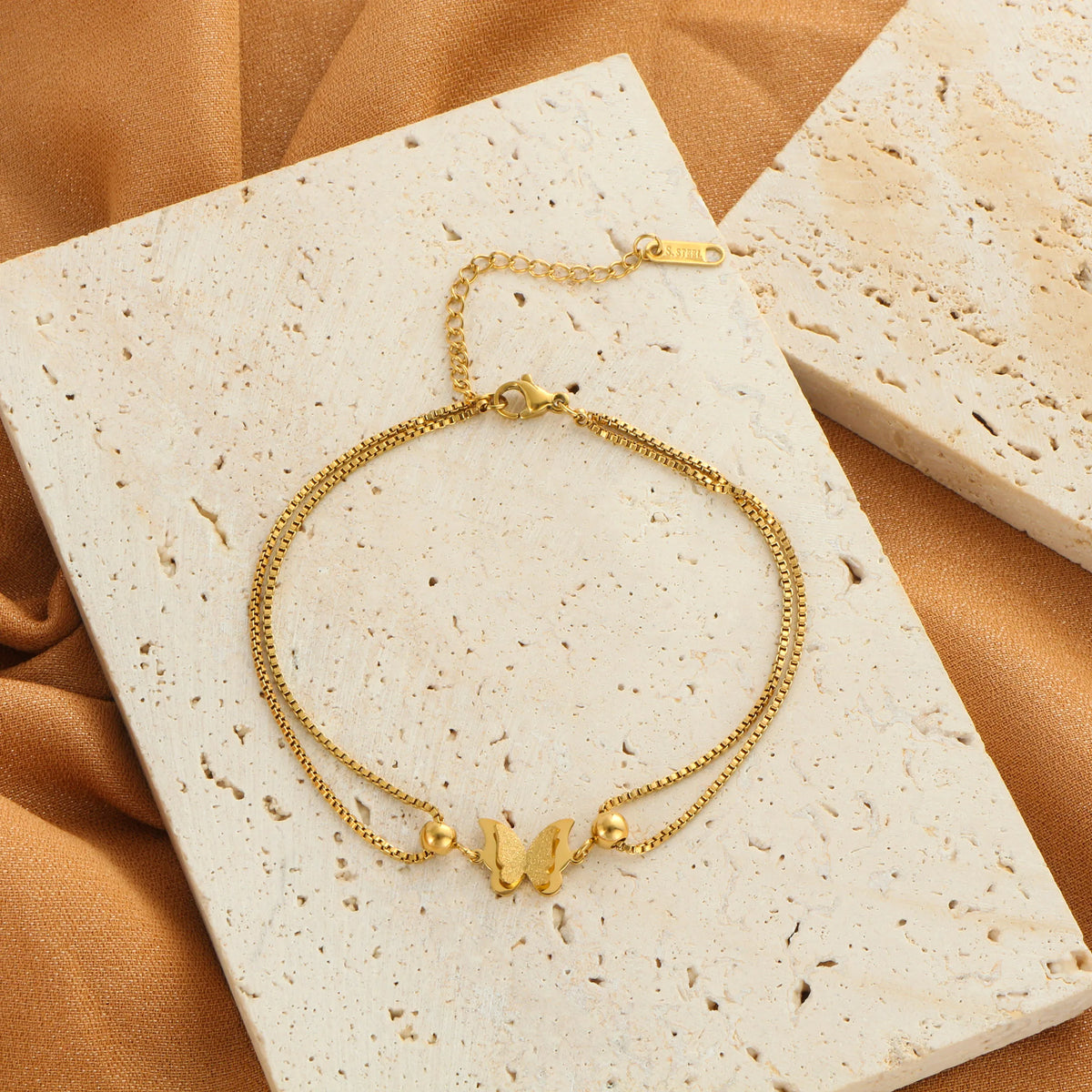 Frosted butterfly anklet in gold and silver tones