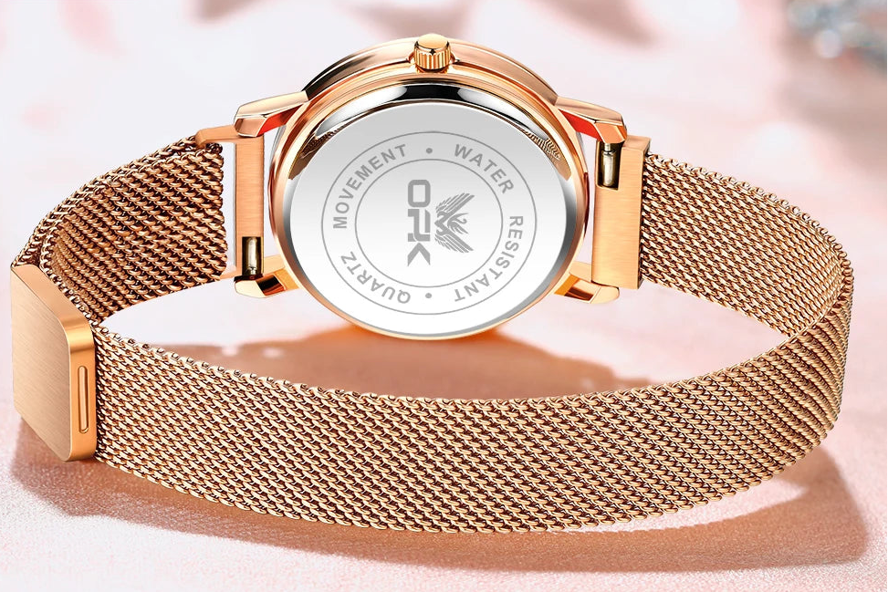 Back view of rose gold watch showing mesh band and clasp