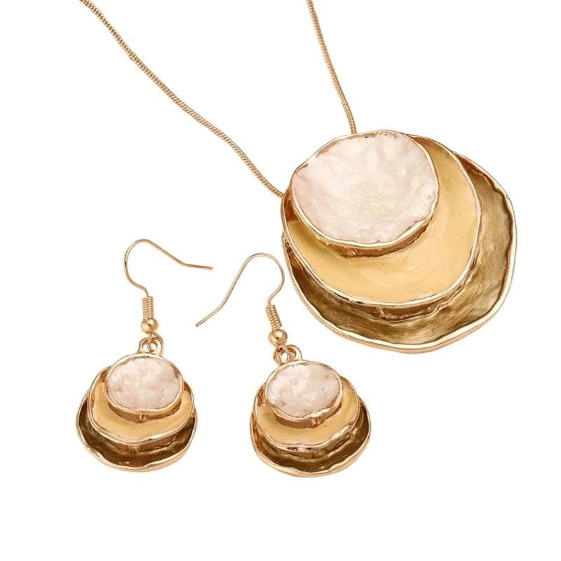 Gold necklace and earrings with beige stones on a white background