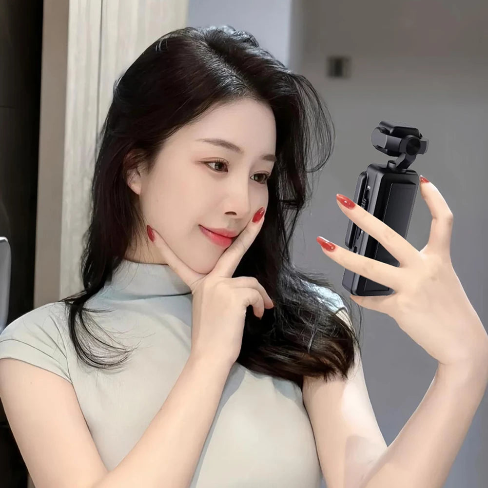 Woman taking a selfie with a smartphone and a gimbal stabilizer.