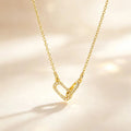 Gold interlocking heart paperclip necklace with clear zircon accents