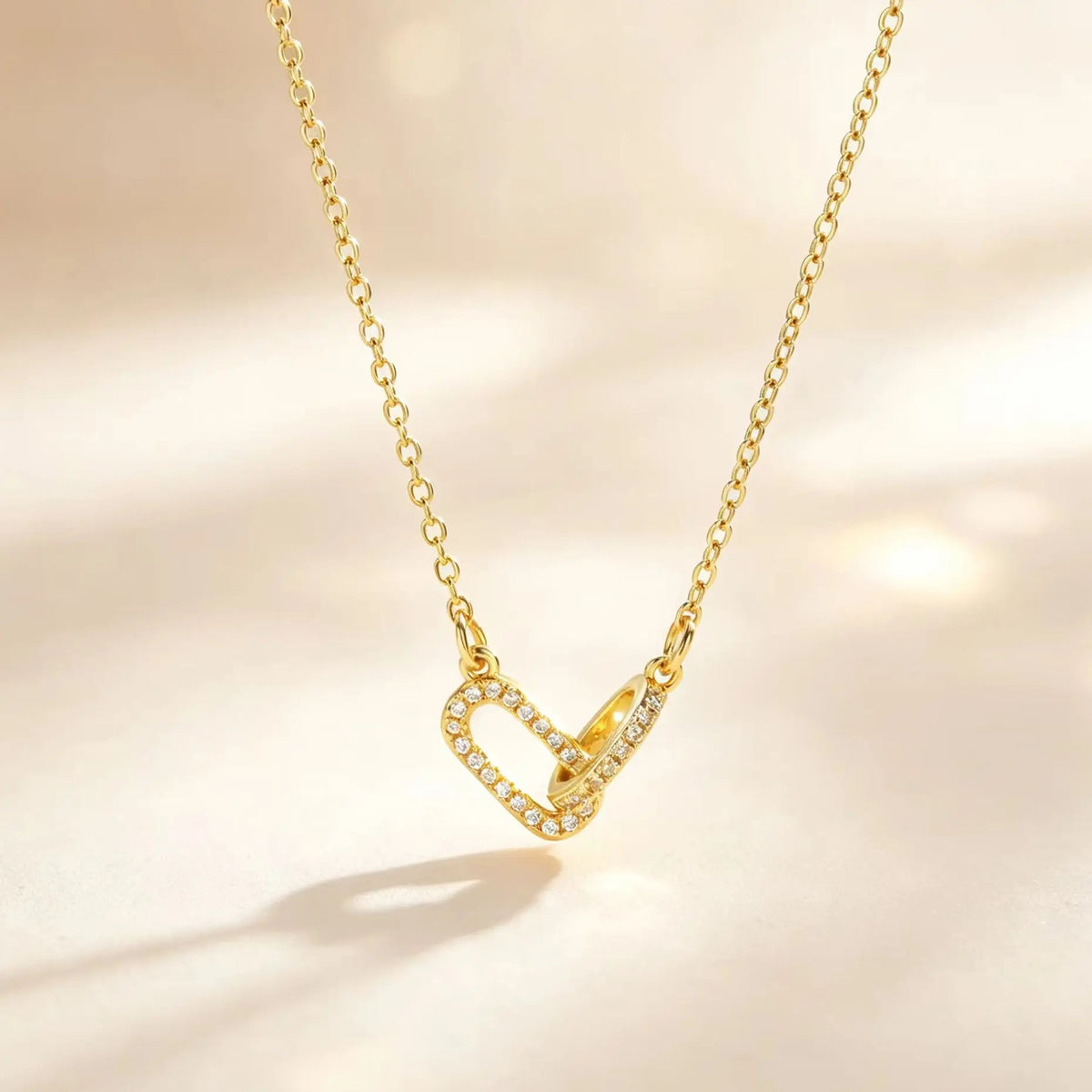 Gold interlocking heart paperclip necklace with clear zircon accents