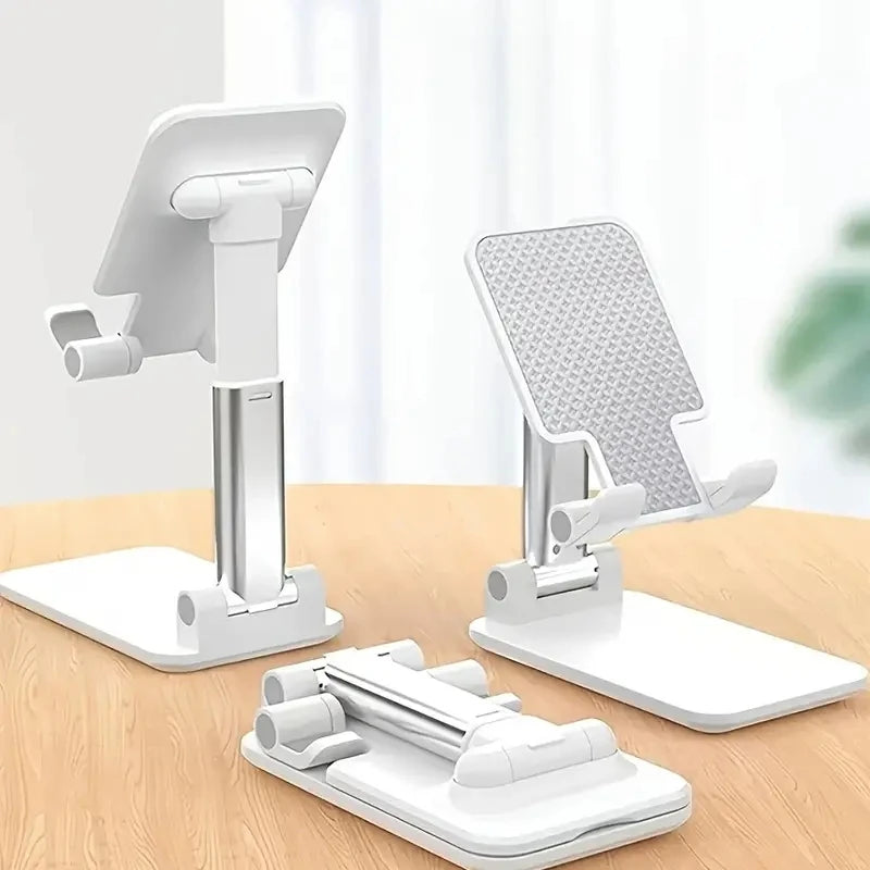 Set of white adjustable phone stands on a wooden surface with a blurred background