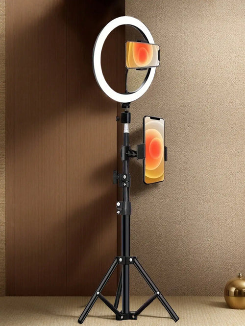Ring light on a stand with a smartphone attached, against a brown wall.