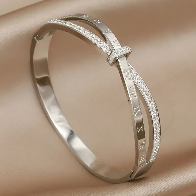 Silver bracelet with diamond accents on a beige fabric background