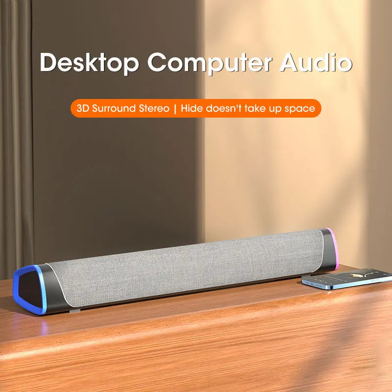 Desktop computer audio speaker on a wooden surface with text highlighting features