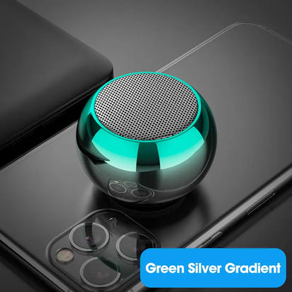 Mini orb speaker glowing while placed on mobile device
