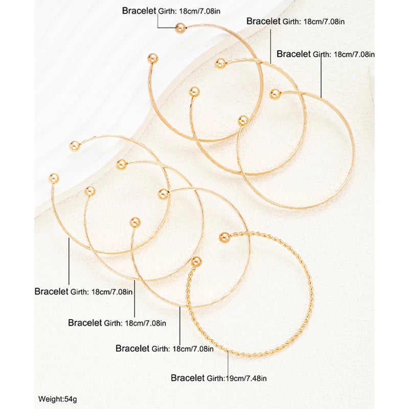Gold bracelet with labeled girth measurements on a white background