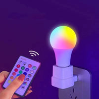 Colorful smart light bulb with remote control on a dark background
