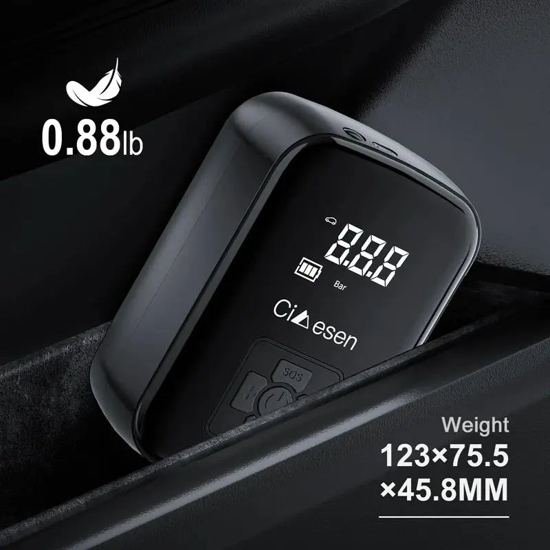 Black tire pressure monitor with digital display on a dark background