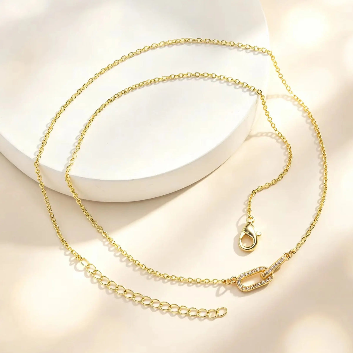 Gold interlocking heart paperclip necklace with clear zircon accents