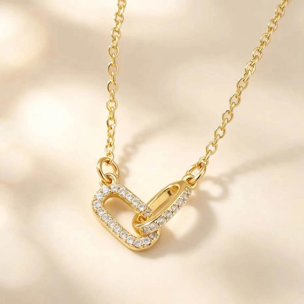 Gold interlocking heart paperclip necklace with clear zircon accents