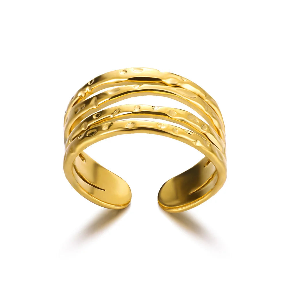 “Gold open ring with textured design on a white background”