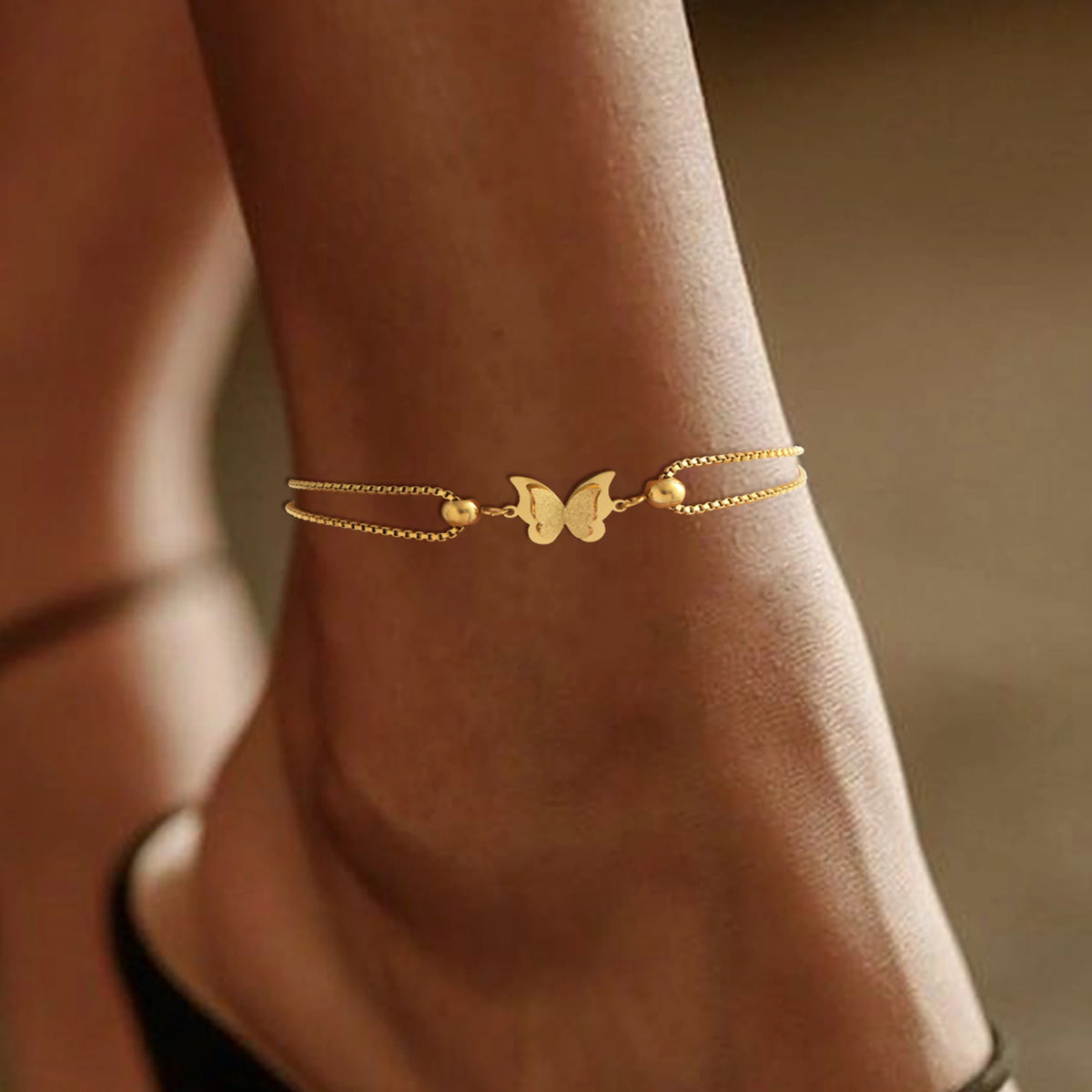 Frosted butterfly anklet in gold and silver tones