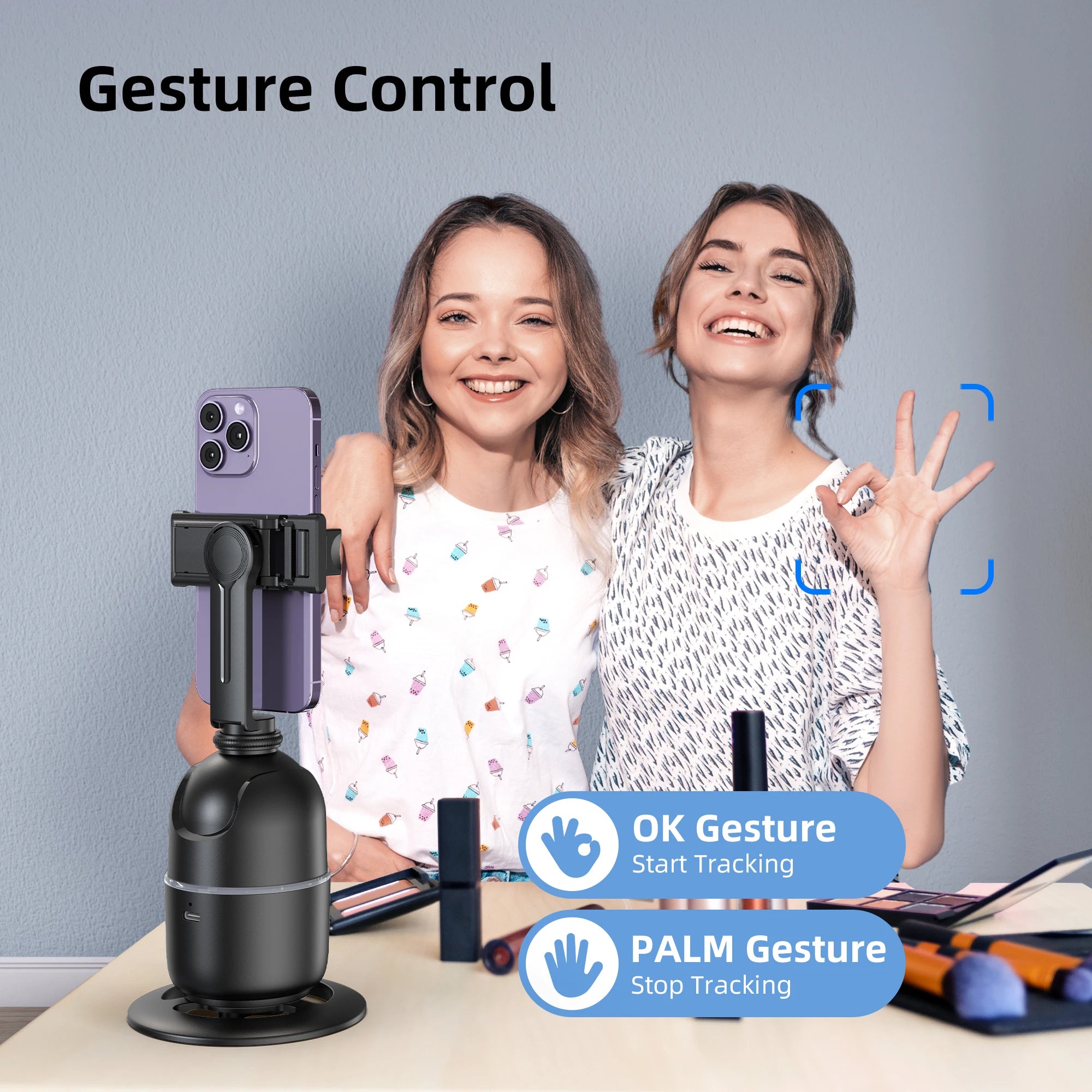 Two women using a smartphone with a gesture control device, showing OK and palm gestures.
